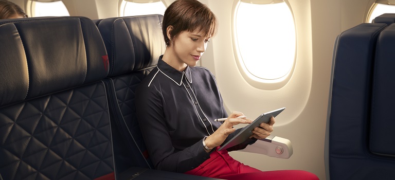 Customer watching tablet on plane